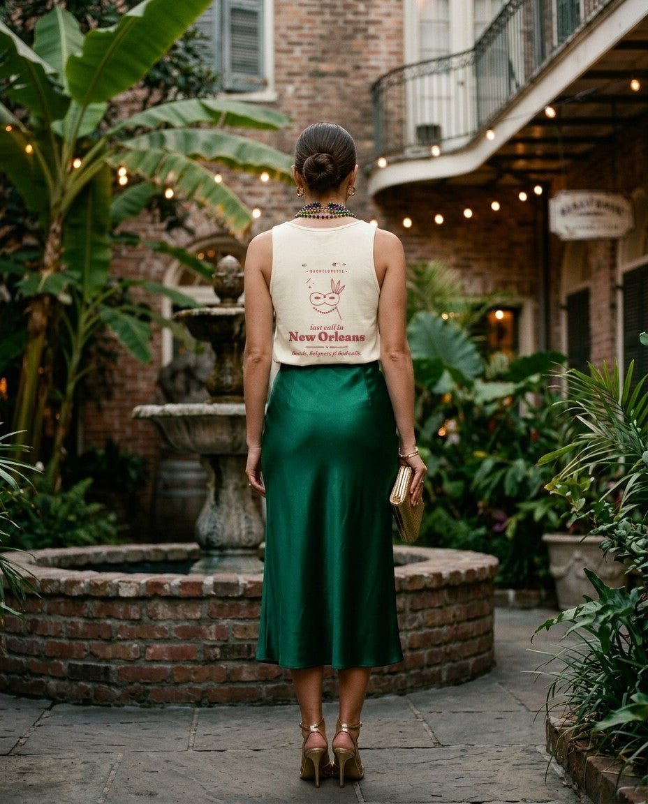 New Orleans Bachelorette Tank Top in Ivory with an emerald satin skirt in a courtyard