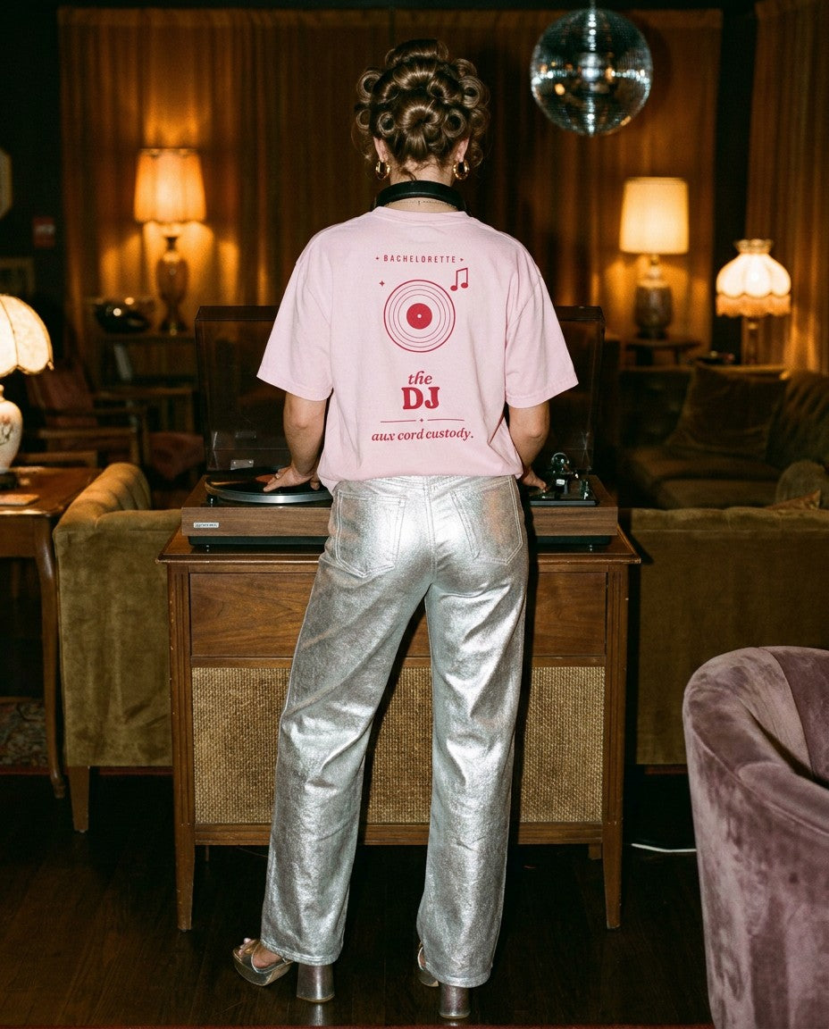 The DJ Oversized Tee in Blossom with silver metallic trousers at a record player