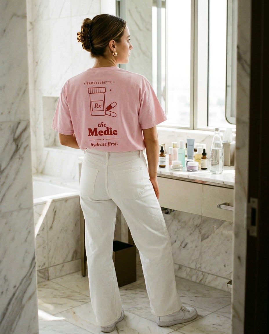 The Medic Oversized Tee in Blossom with white wide-leg jeans in a marble bathroom